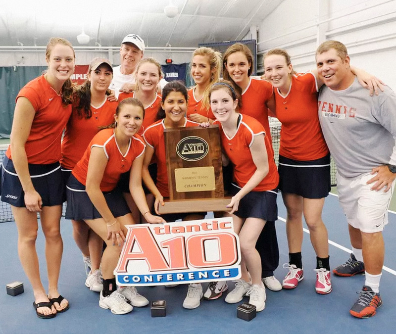 The 2011 University of Richmond Women's tennis team post holding the A-10 championship trophy.