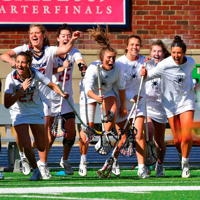 The University of Richmond women's lacrosse team charges on to the field, celebrating an A-10 win.