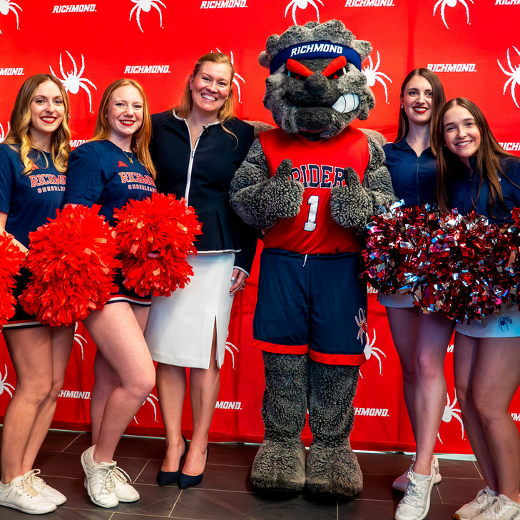 Women's basketball coach Alisa Kresge with WebstUR and Spider cheerleaders