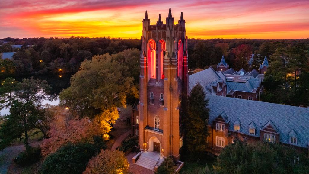 Photograph of Boatwright Library tower at sunset pink and yellow sky
