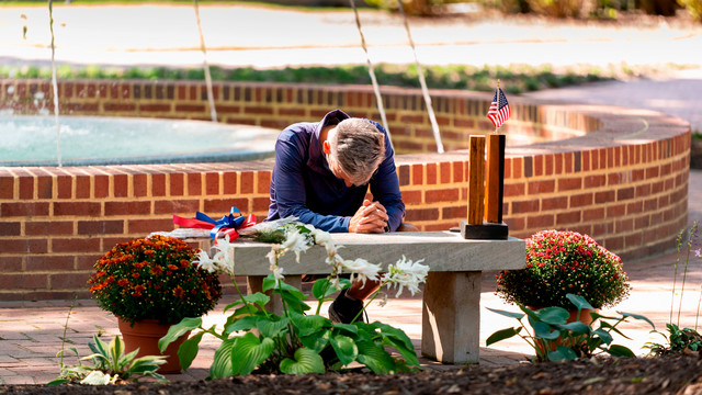 A visitor at the 9/11 memorial bench at the University of Richmond