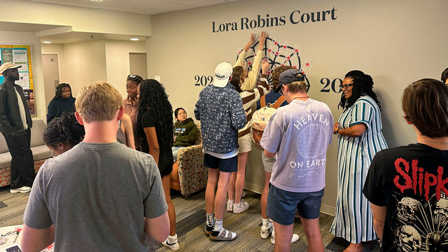 Faculty In Residence Dr. Shannon Jones with students on Spider Mural Day.