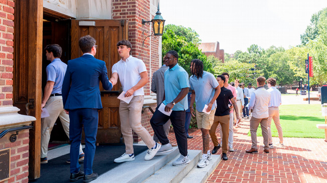 Richmond College students in slacks and polo shirts entering Cannon Memorial Chapel for Investiture 2026