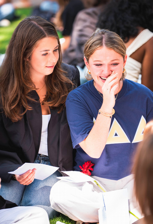 Two Westhampton College students reading notes and smiling during Proclamation 2026
