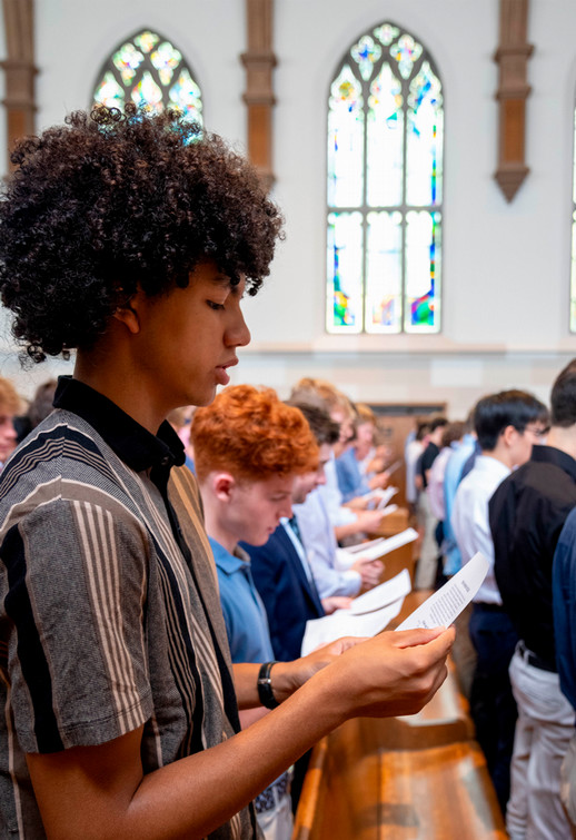 Richmond College student in Cannon Memorial Chapel reading aloud from a sheet of paper