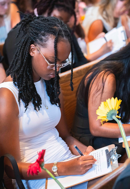 First-year Westhampton College student in a white dress writes a letter to her future self
