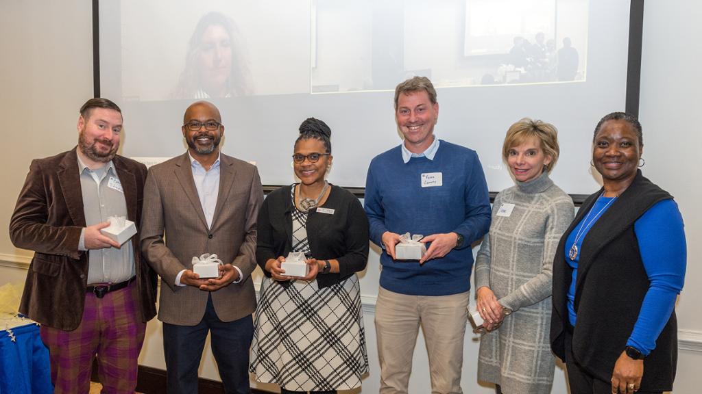 Award winners standing with the dean