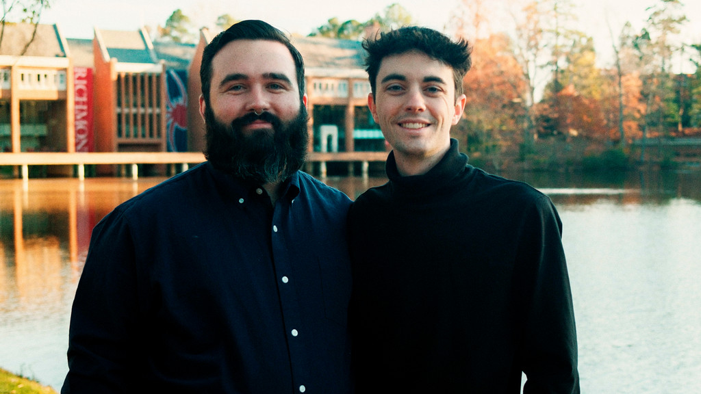 Brandon and Tanner posing in front of Westhampton Lake and the Commons