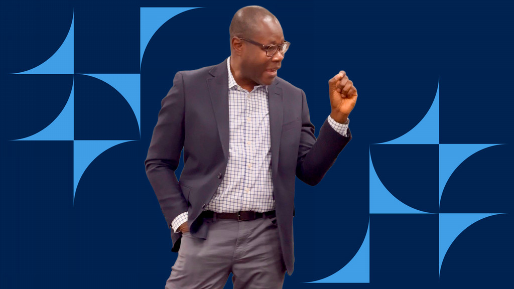 Photo of Fred Gatty speaking superimposed on a blue background with multiple lighter blue shapes surrounding him