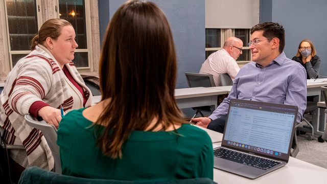 Andrew Schoeneman interacting with students in the classroom