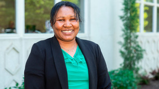 Headshot of Nyreng Dut outside the Special Programs Building