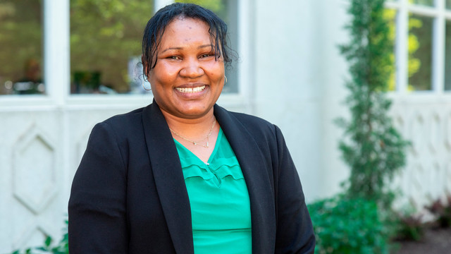 Headshot of Nyreng Dut outside the Special Programs Building