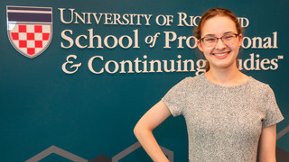 Headshot of Grace Riley in front of the SPCS logo