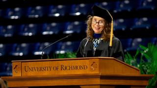 Jennifer Smith-Slabaugh speaking at the University of Richmond podium during SPCS Commencement