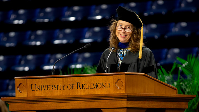 Jennifer Smith-Slabaugh speaking at the University of Richmond podium during SPCS Commencement