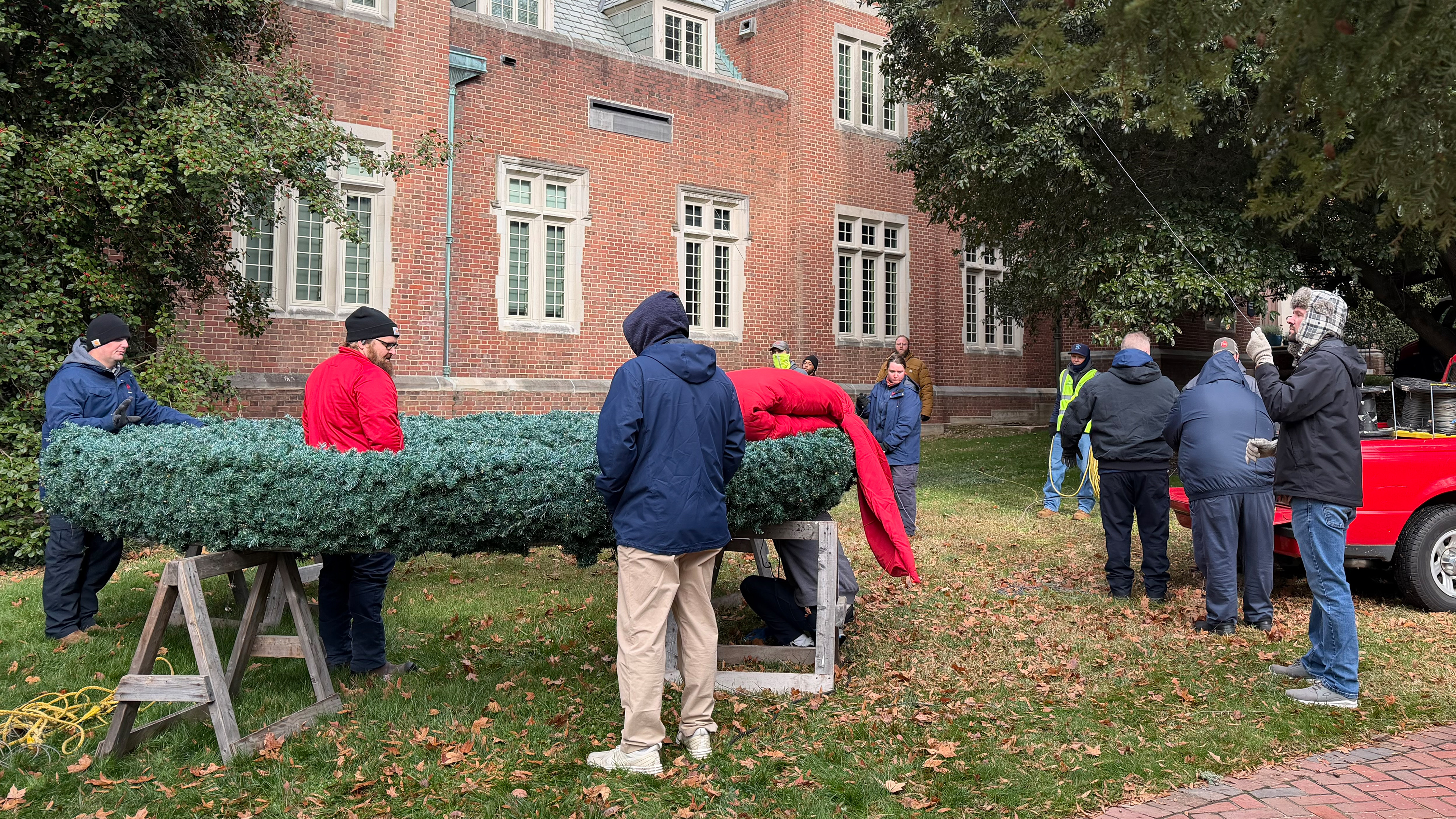 facilities staff hang wreaths on Boatwright Tower