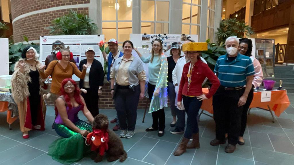 Students and faculty in Halloween costumes for the Spooktacular Science Research Fair