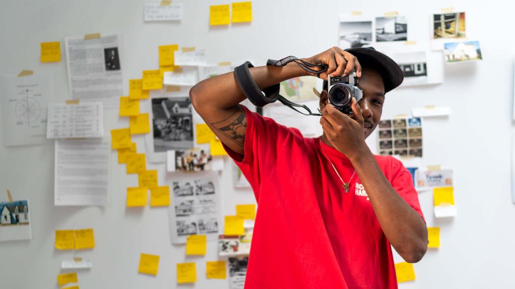 A&S student peering through the lens of a camera.