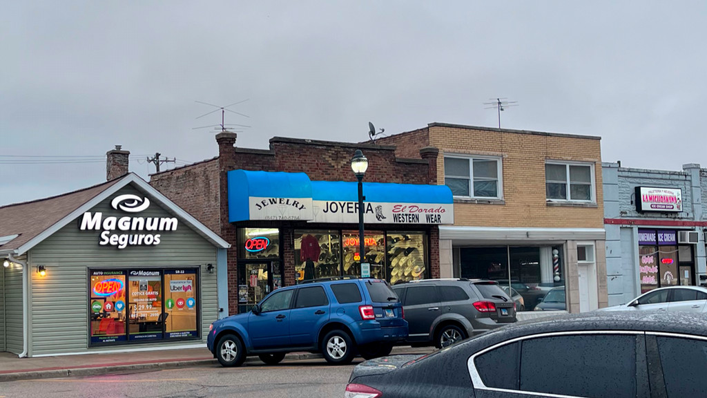 Shops with signs in Spanish lining a street.