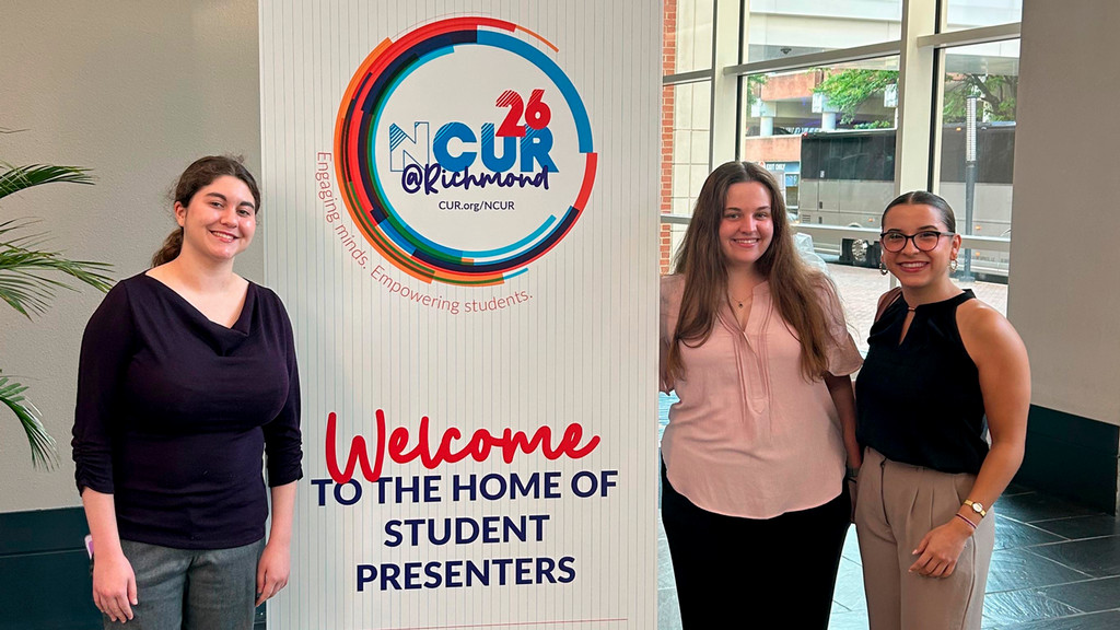 Students in front of NCUR 2026 conference sign