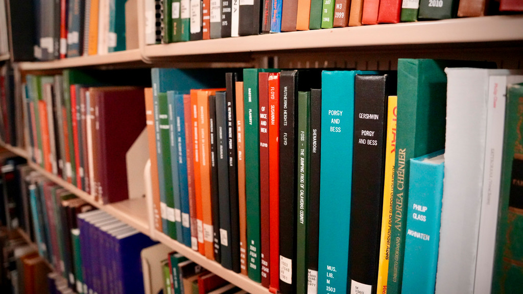 Scores sitting on a shelf at Parsons Music Library