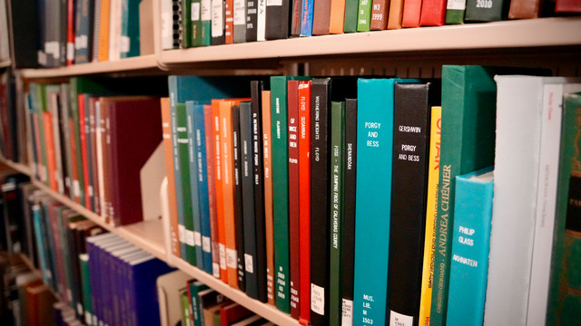 Scores sitting on a shelf at Parsons Music Library