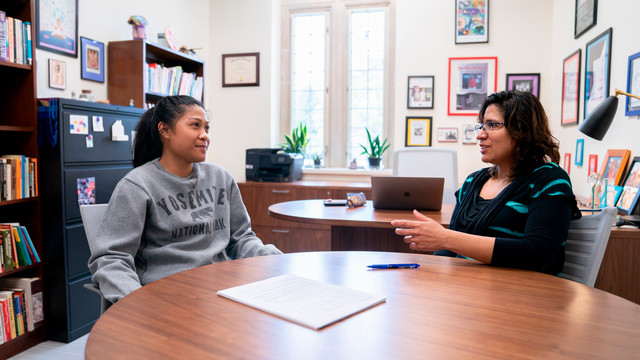 Theatre professor meets with a student during office hours