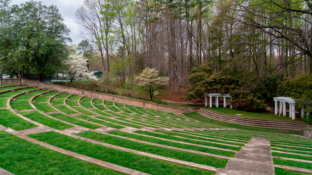 outdoor Greek-style theater with columns and green grass