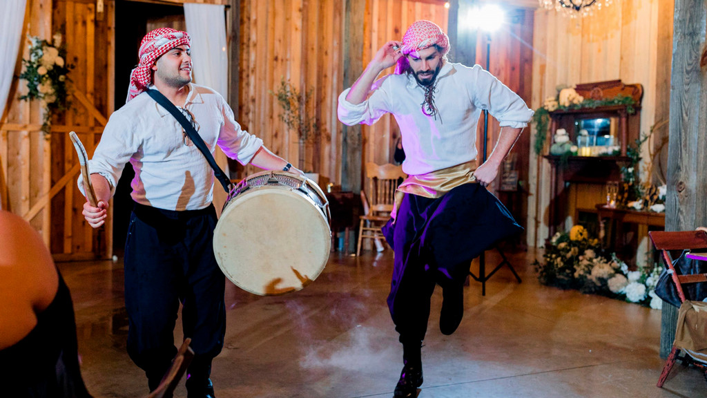 Lifeforce Nafs performers dance and play drum at a celebration