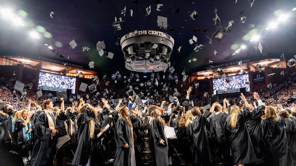 graduates throwing hats in the air