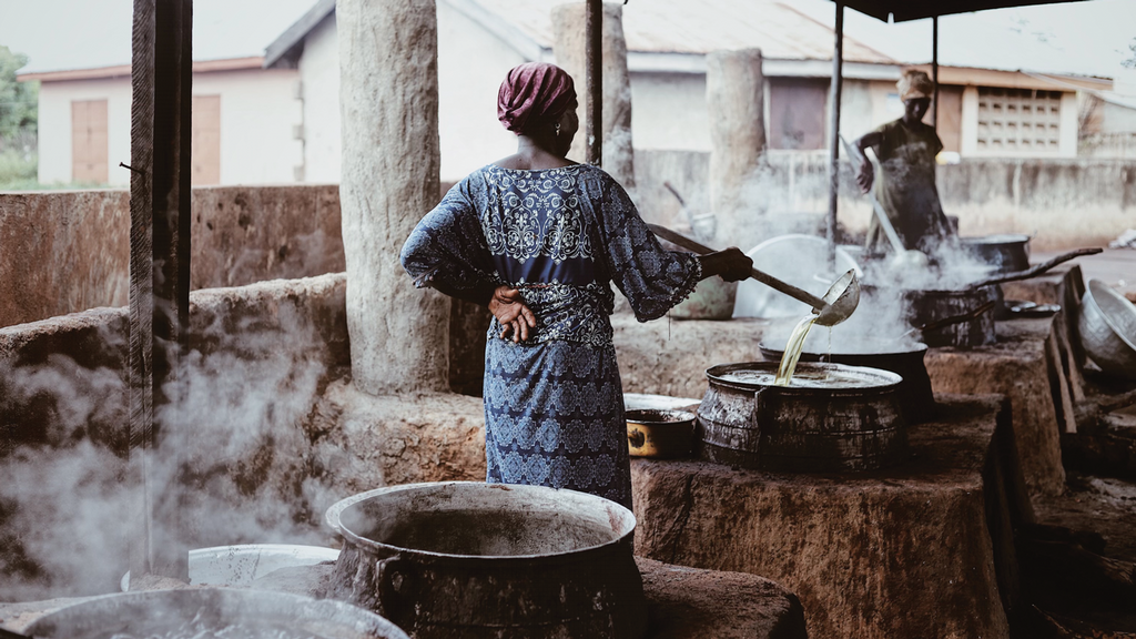 A woman stirring a pot of liquid