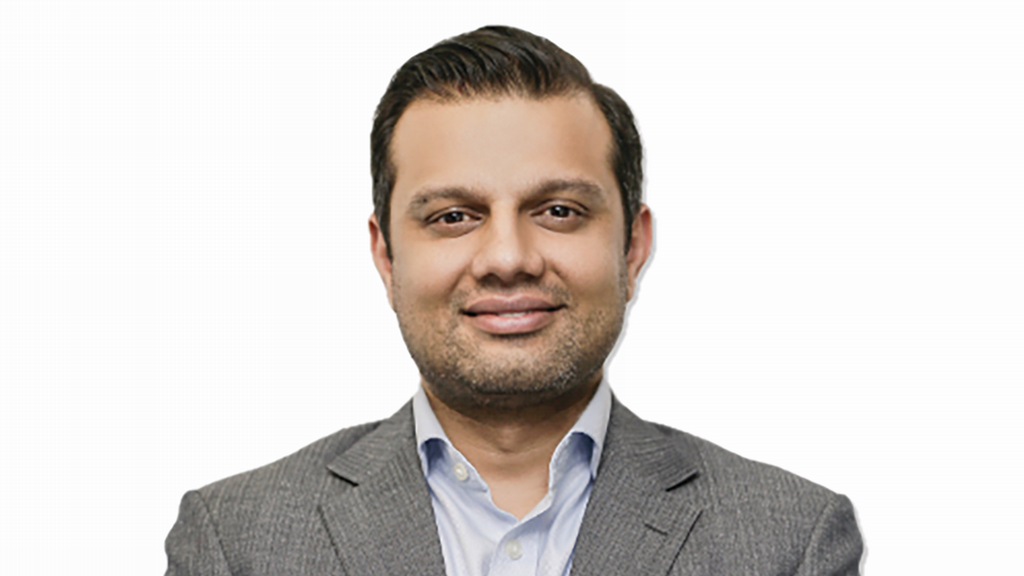 a man in a suit smiling at the camera