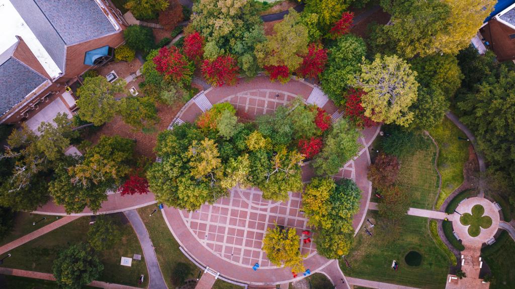 Aerial view of the Forum, a circular brick outdoor space with trees throughout.
