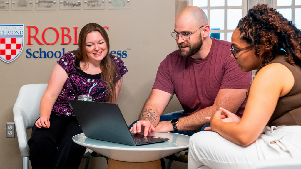Robins students looking at a laptop