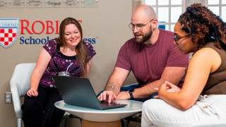 Robins students looking at a laptop