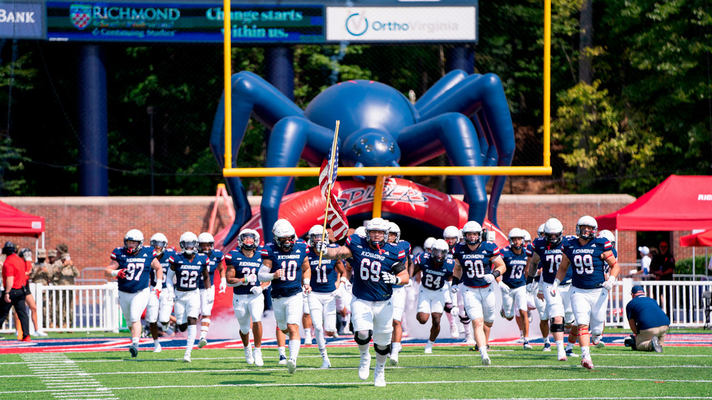 Spiders Football Team running onto the field