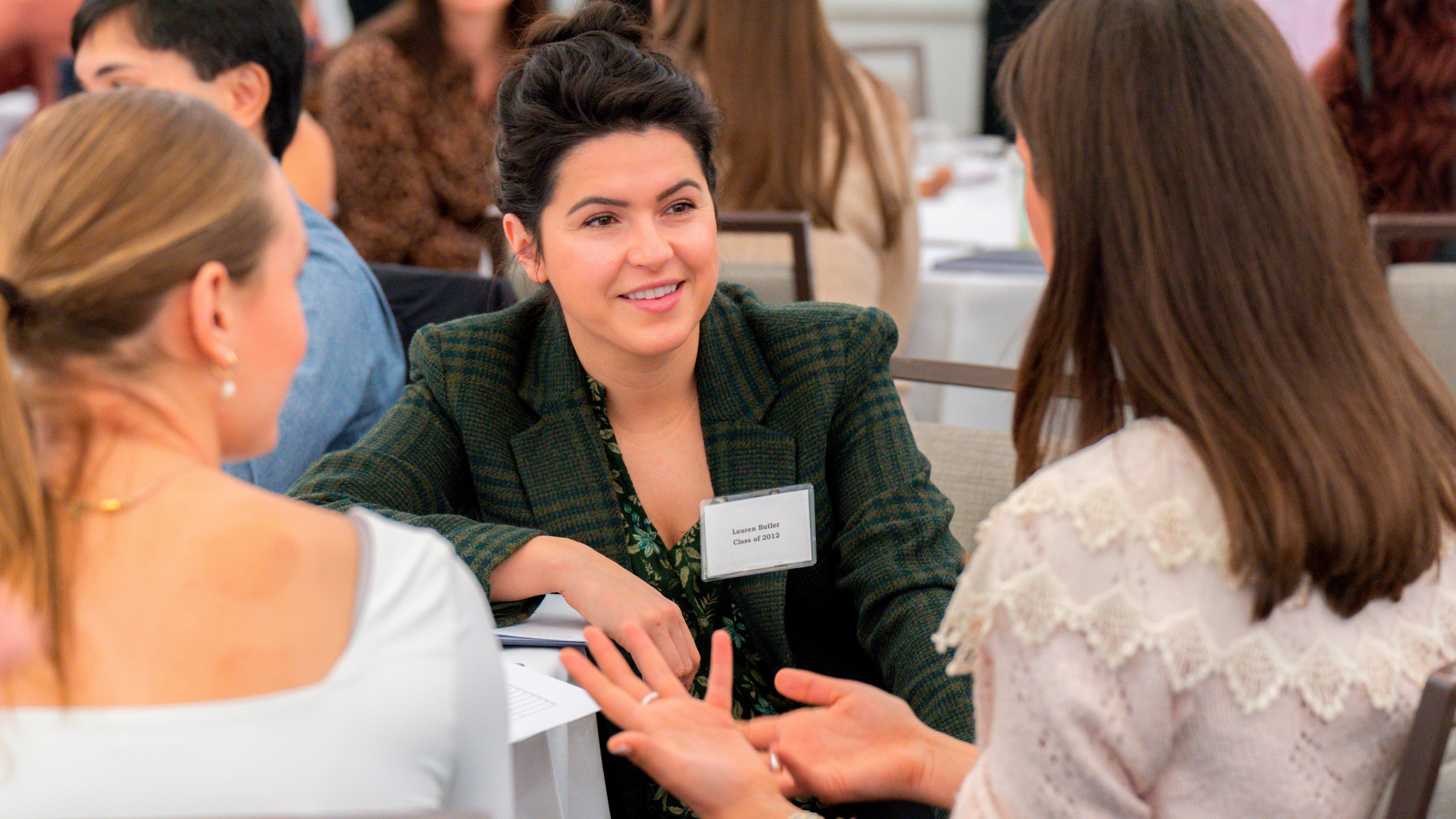 A photo of Lauren Butler, class of 2012, speaking with two students at the Jepson Edge forum