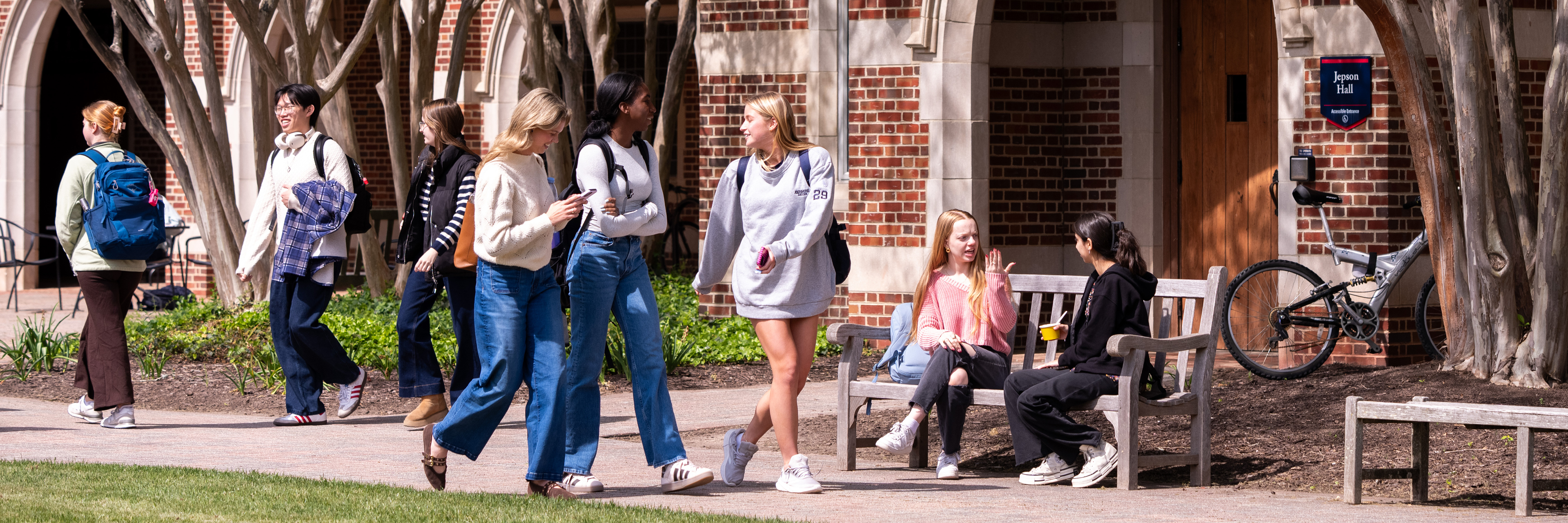 A group of students walk through Stern quad in front of Jepson Hall
