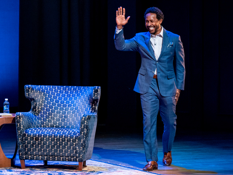 Former football player and ESPN sports analyst Desmond Howard walks on stage at the Jepson Forum at the University of Richmond.