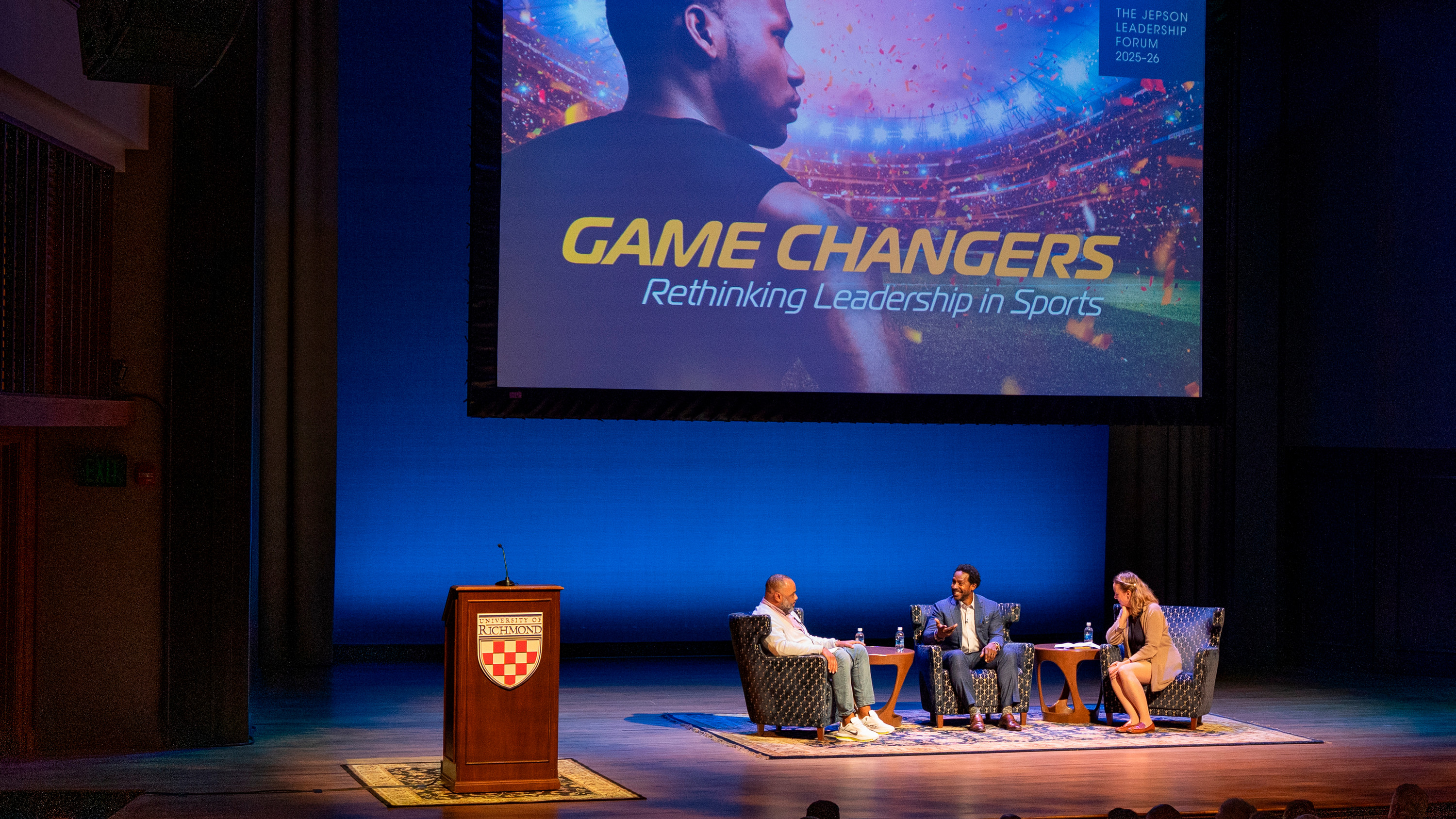 A photo of the Jepson Forum discussion "Game Changers: Rethinking Leadership in Sports." Three panelists - Dr. Julian Hayter, Dr. Jessica Flanigan, and former football player and ESPN sports analyst Desmond Howard.