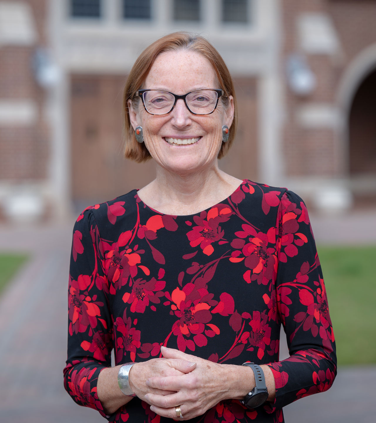 An environmental portrait of dean Sandra Peart, standing in front of Jepson Hall on the University of Richmond campus
