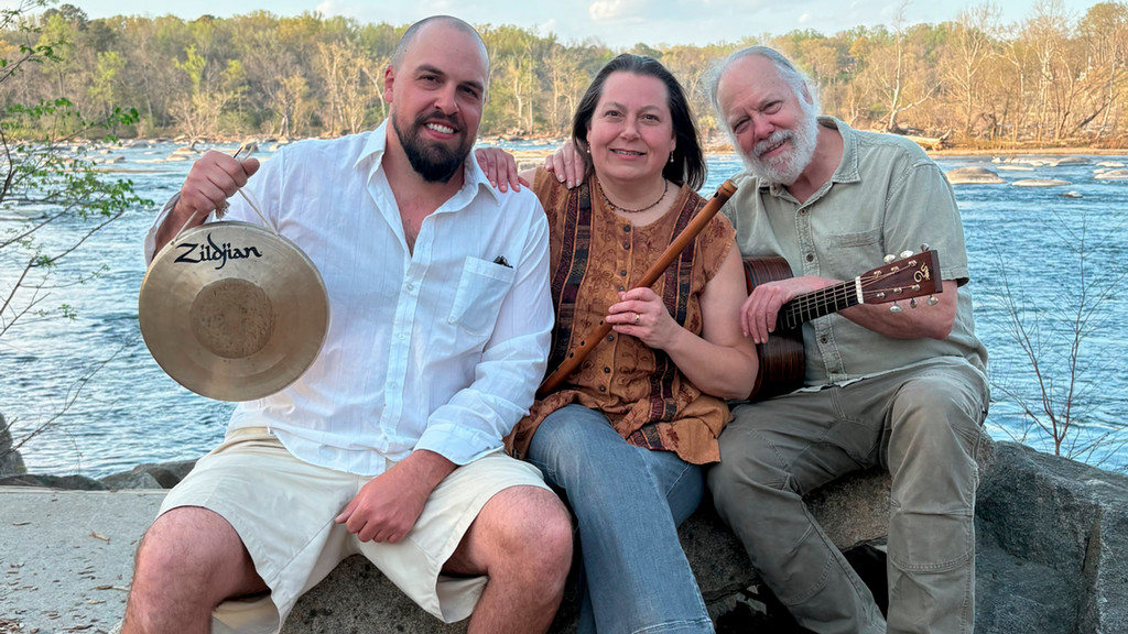 Guitarist Cory Blake with his trio posing outside at the James River