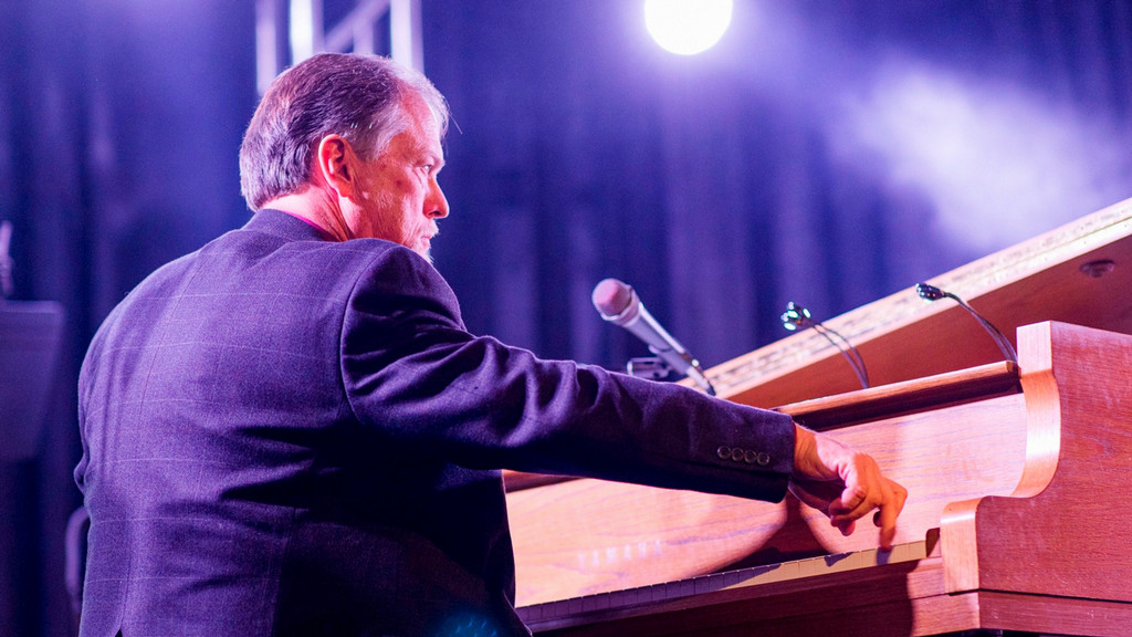 David Esleck plays the piano on stage during a jazz concert