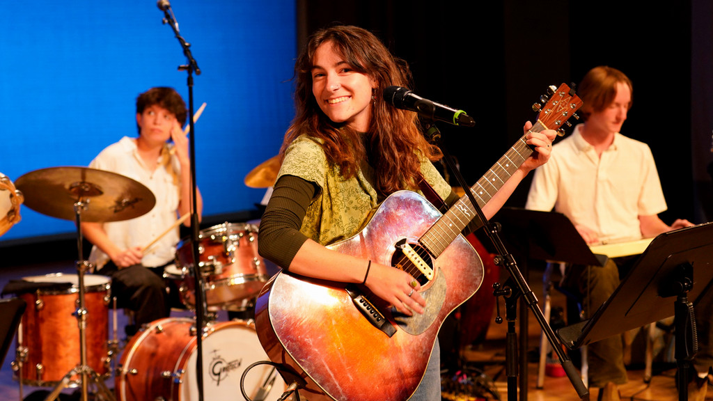 female guitarist leads a contemporary music combo