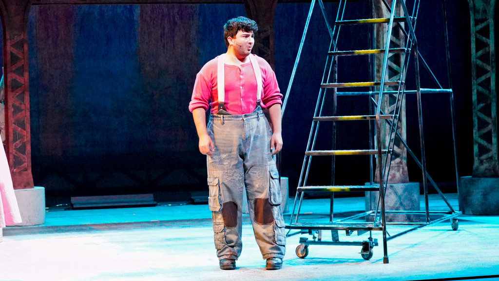 musical theater actor sings solo on stage