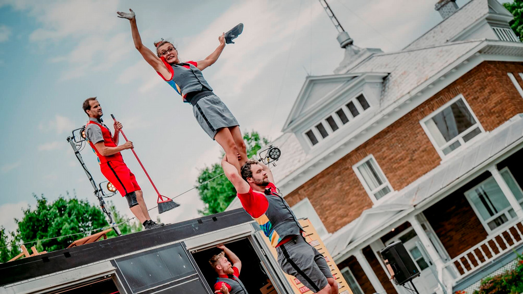 one acrobat standing on the shoulders of another