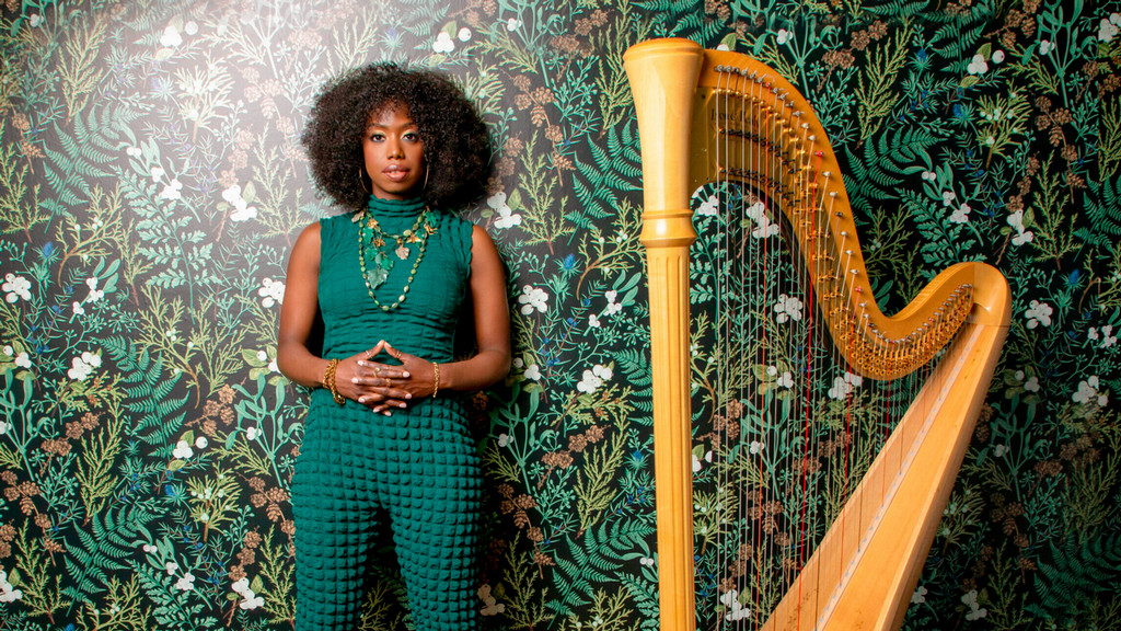 Brandee Younger stands beside her harp