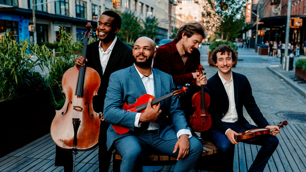 Isidore String Quartet pose together on a city street