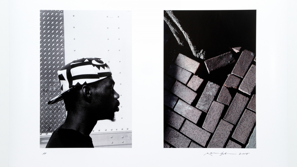 B&W image with male in a baseball cap and a grid of bricks
