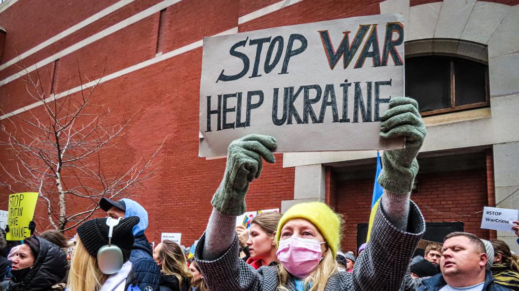 woman holding sign supporting ukraine